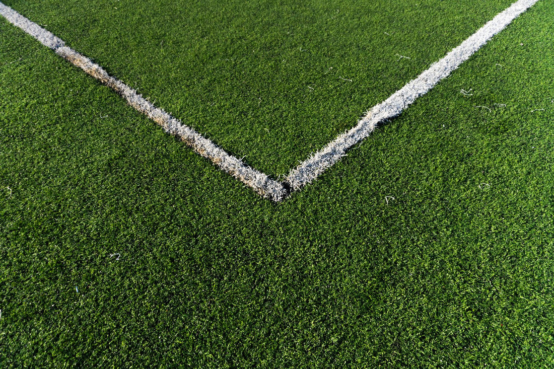 Detailed view of a soccer field corner with vibrant green artificial turf in Istanbul.
