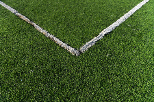 Detailed view of a soccer field corner with vibrant green artificial turf in Istanbul.